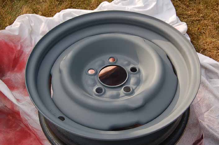 Photo shows the trailer wheel primed and ready for the spray painted color coats to be applied
